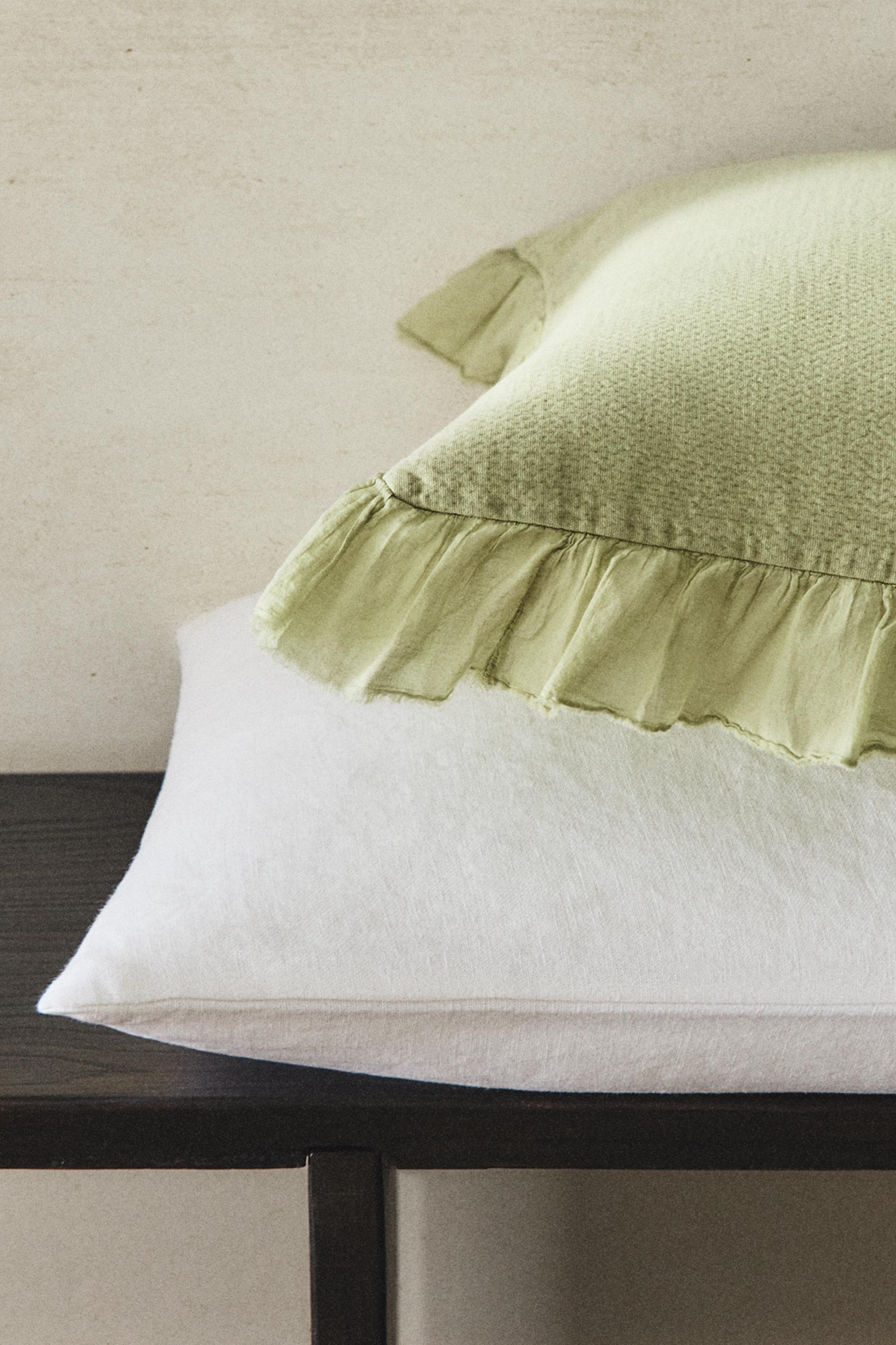 TEXTURED THROW PILLOW COVER WITH RUFFLE TRIM